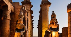 Trip to Egypt: Pyramids & Nile by Flight price Illuminated statues and columns at Luxor Temple during sunset in Egypt.
